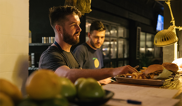 image of Tom Arnel behind counter at tom & serg